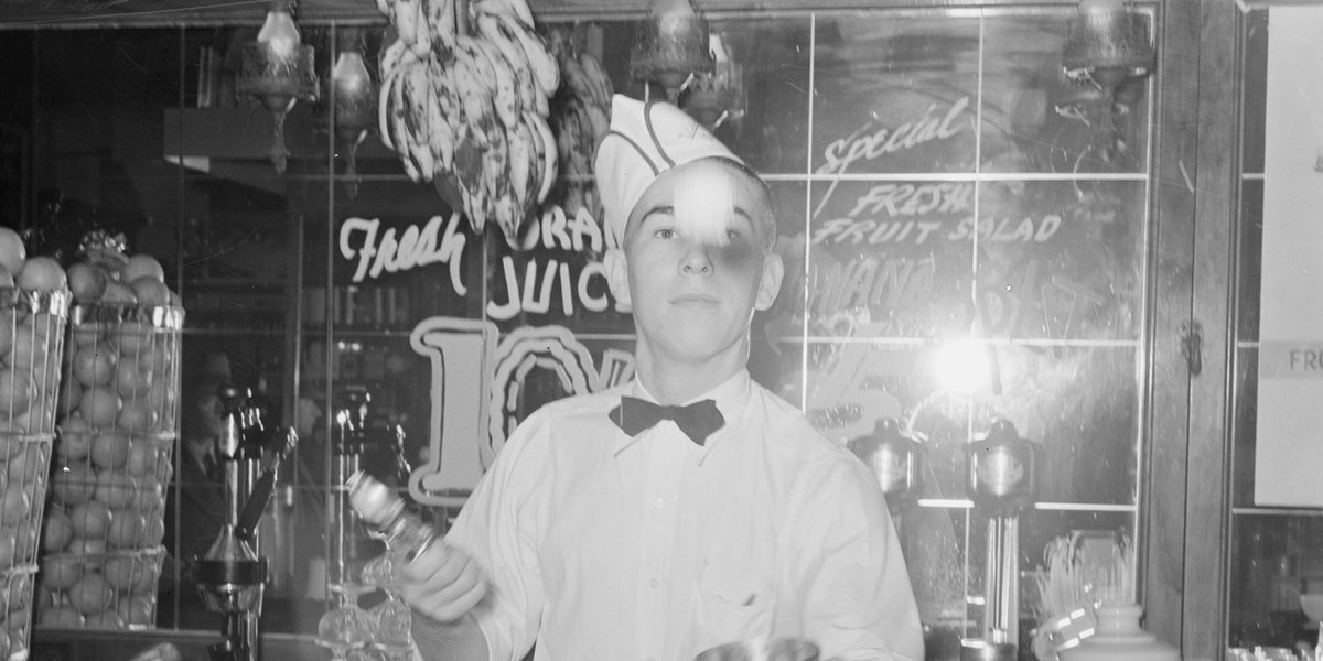 Soda jerker flipping ice cream into malted milk shakes. Corpus Christi, Texas. Used to illustrate the How to jerk a drink recipe.